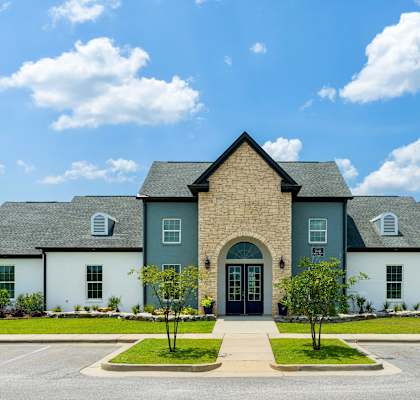 a house with a cloudy blue sky in the background
