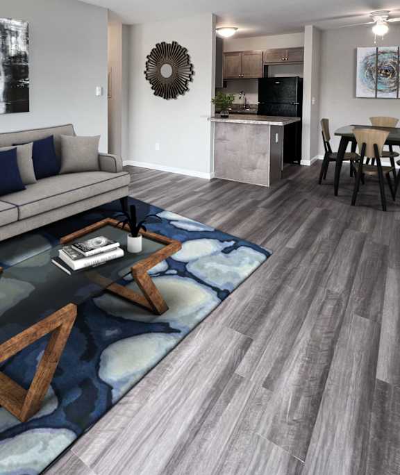 an empty living room with wood flooring and a blue door  at Wyndemere Apartments, Franklin, 45005