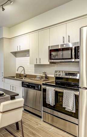 A modern kitchen with a dining table and chairs.
