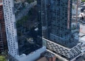 Thumbnail 30 of 31 - an aerial view of a tall building in the city