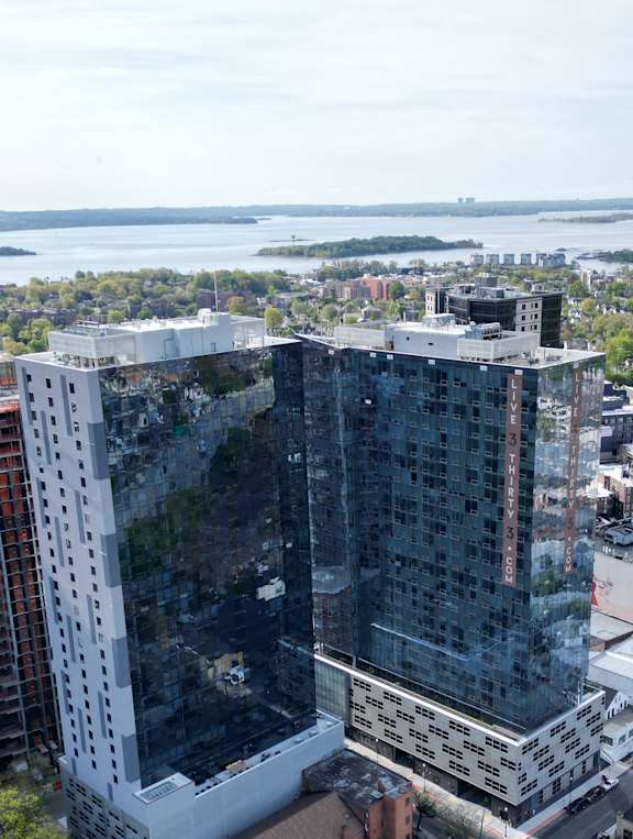 an aerial view of a tall building in the city