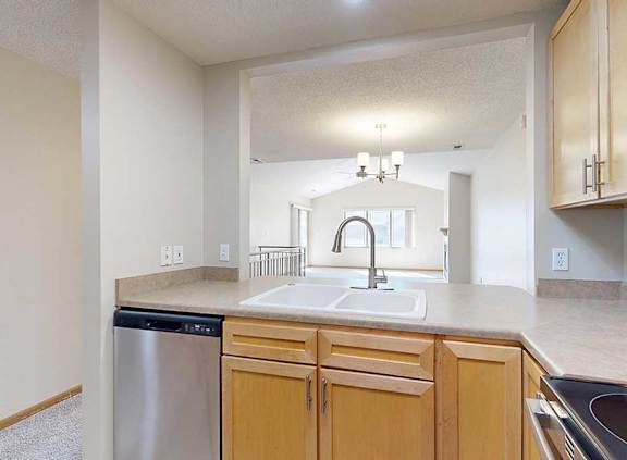 a kitchen with stainless steel appliances and wooden cabinets