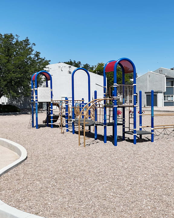 A playground with a blue sign that says "No Parking" in front of a building.