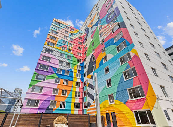 A tall building with a colorful mural on its side.
