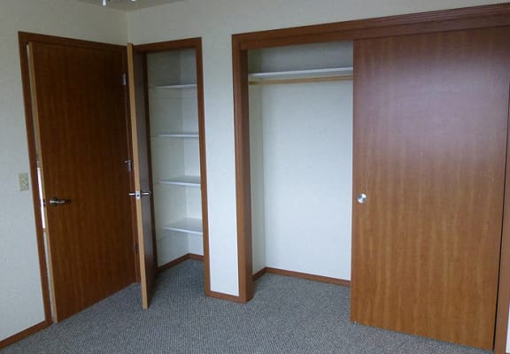 Image of small closet with shelves and larger with hanger rack