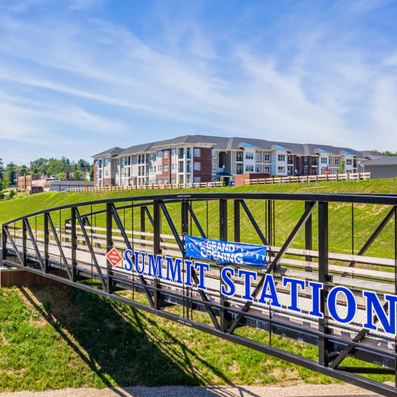 a bridge with a building in the background and a sign on it