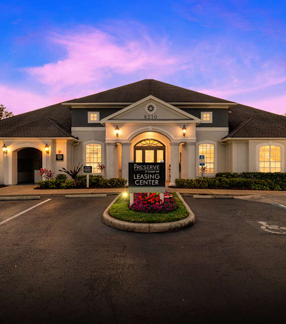 A Preserve Leasing Center building with a parking lot in front.