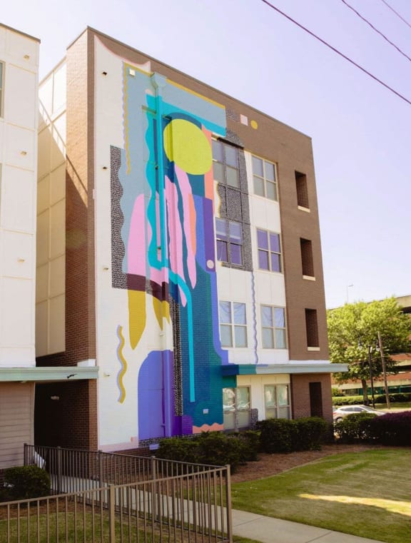 a mural on the side of an apartment building  at Canalside, Augusta, GA