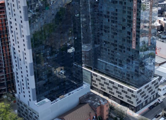 an aerial view of a tall building in the city
