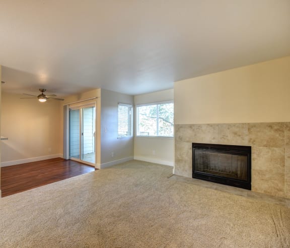 Vacant apartment home with wood brining fireplace in the living room.  Living room has lighter colored carpeting.at Folsom Ranch, California, 95630