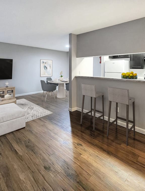 a living room and kitchen with a couch and a bar