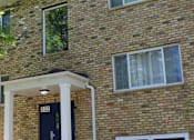 Thumbnail 1 of 7 - a view of the side of a brick building with windows