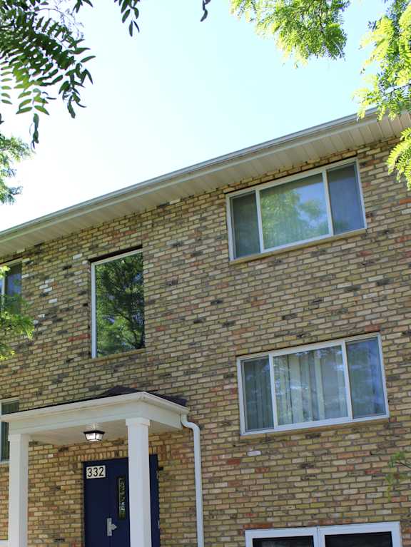 a view of the side of a brick building with windows