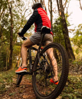 Man Riding Bike Through Forest